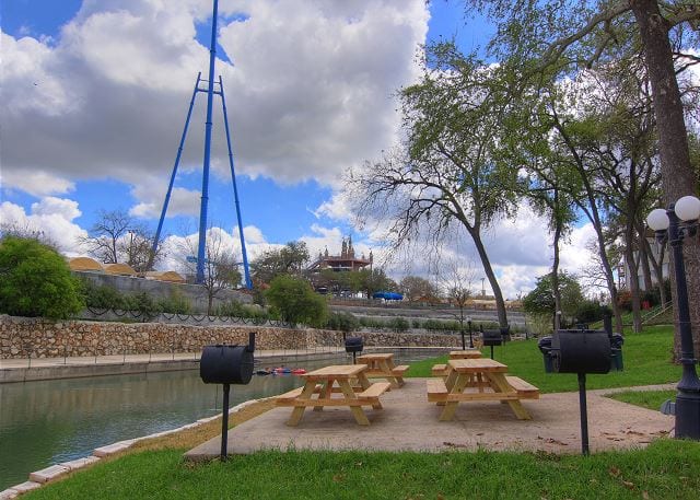 Picnic tables and bbq grills next to Comal river.