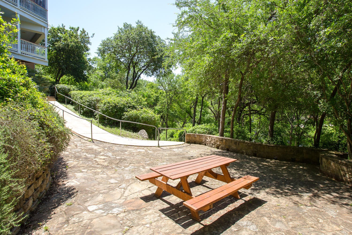 Village at Gruene walkway with picnic table.