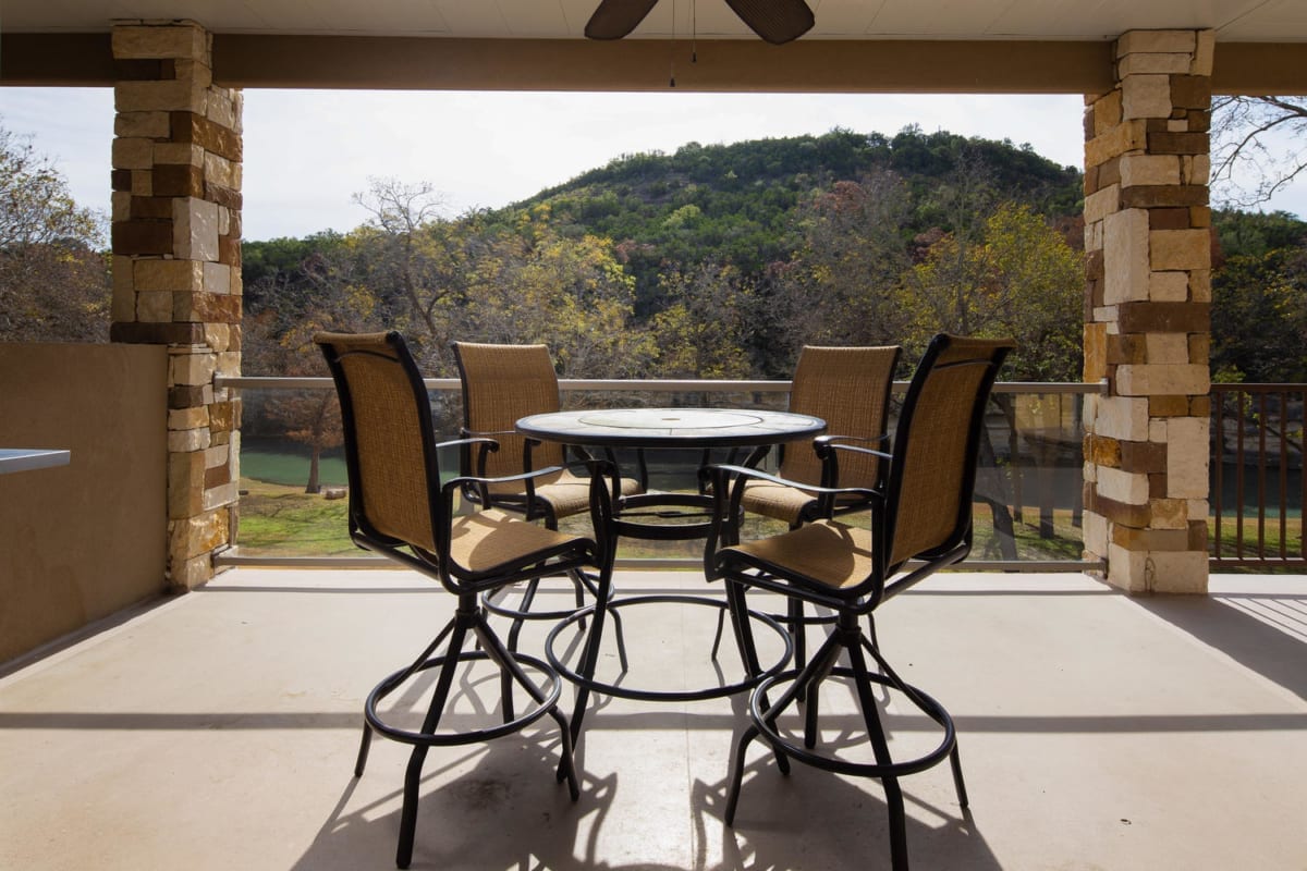 River Run Unit 209 covered balcony with ceiling fan and furniture.