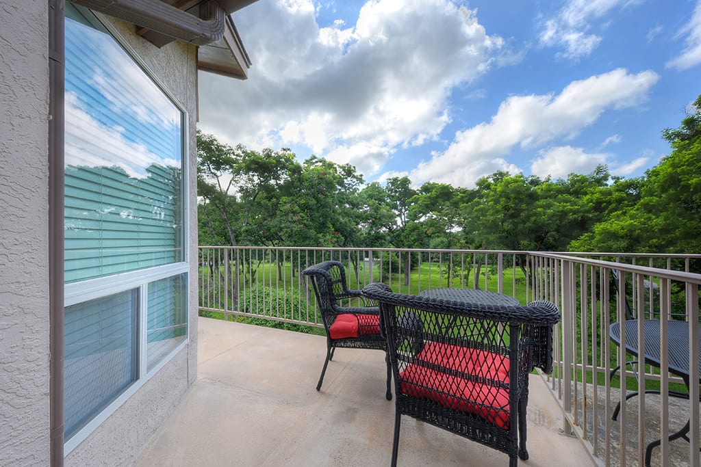 Waterwheel condo balcony with furniture.