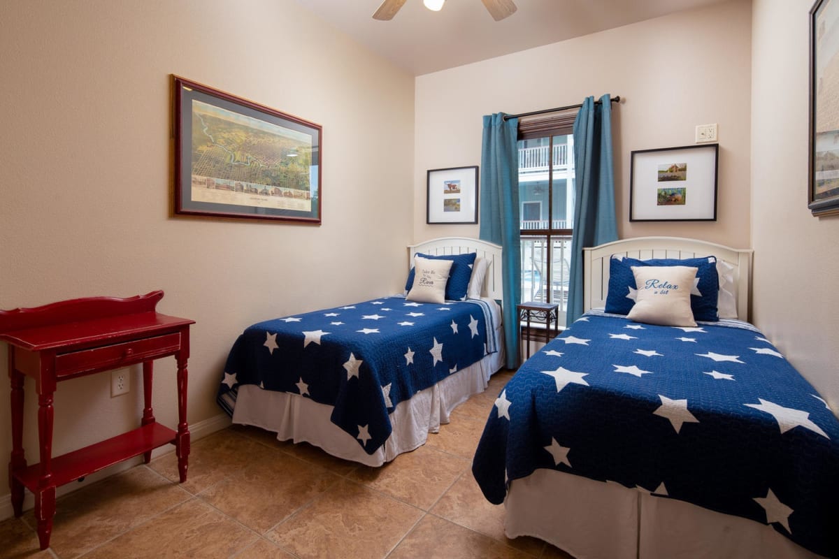 Village at Gruene condo bedroom with two single beds.