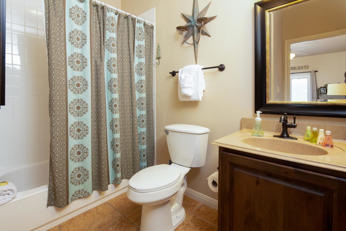 Village at Gruene condo bathroom with shower/tub combo.