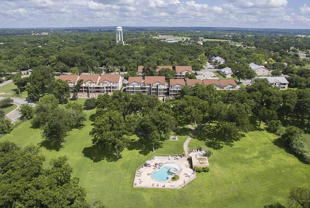 Aerial view of Waterwheel condos, lawn, pool.