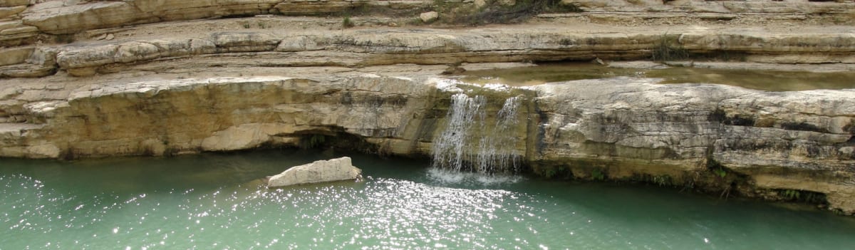 Water running off rocks into a lagoon