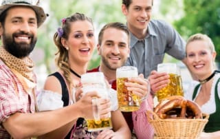 Octoberfest group with beer and pretzels.