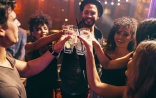 Group toasting drinks at a club.