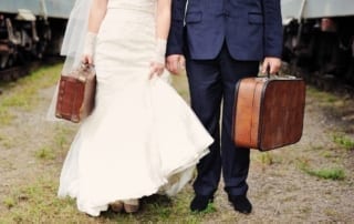 Bride and Groom with suitcases.