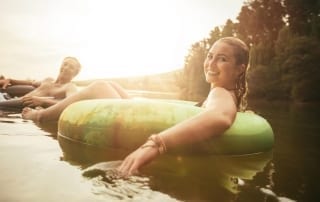 Photo of a Couple Tubing on the Comal. New Braunfels Remains One of the Best Romantic Getaways in Texas.