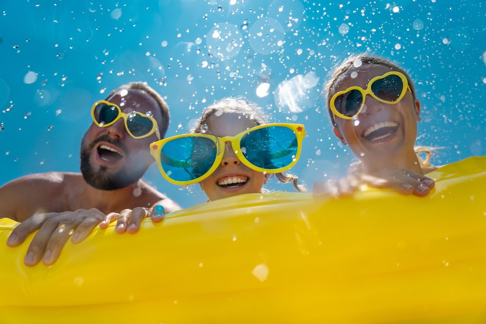 A family of three are enjoying a tubing ride at one of the 2 New Braunfels waterparks.