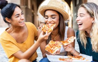 Three women enjoy pizza in New Braunfels.